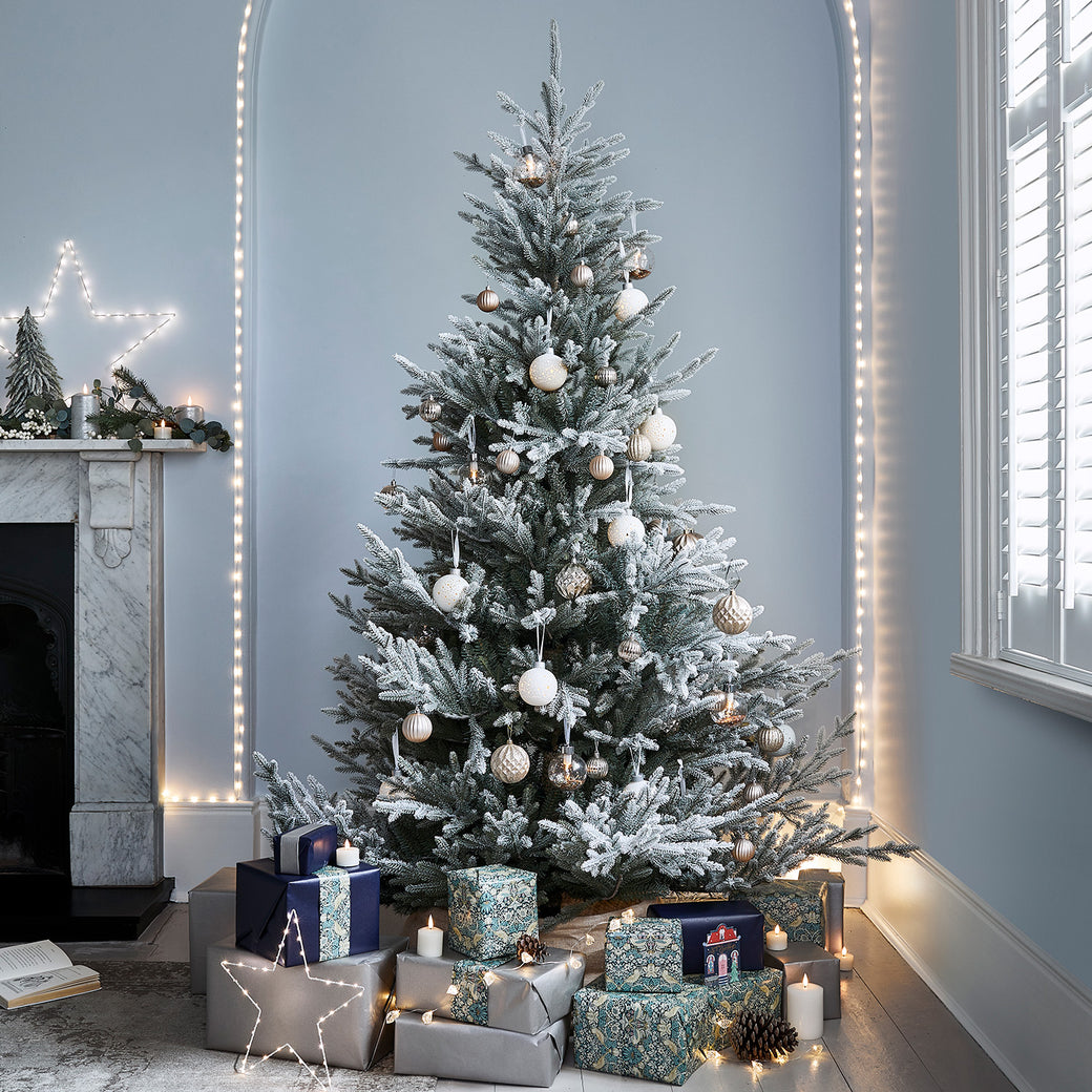 Artificial Christmas tree dressed with decorations and gifts