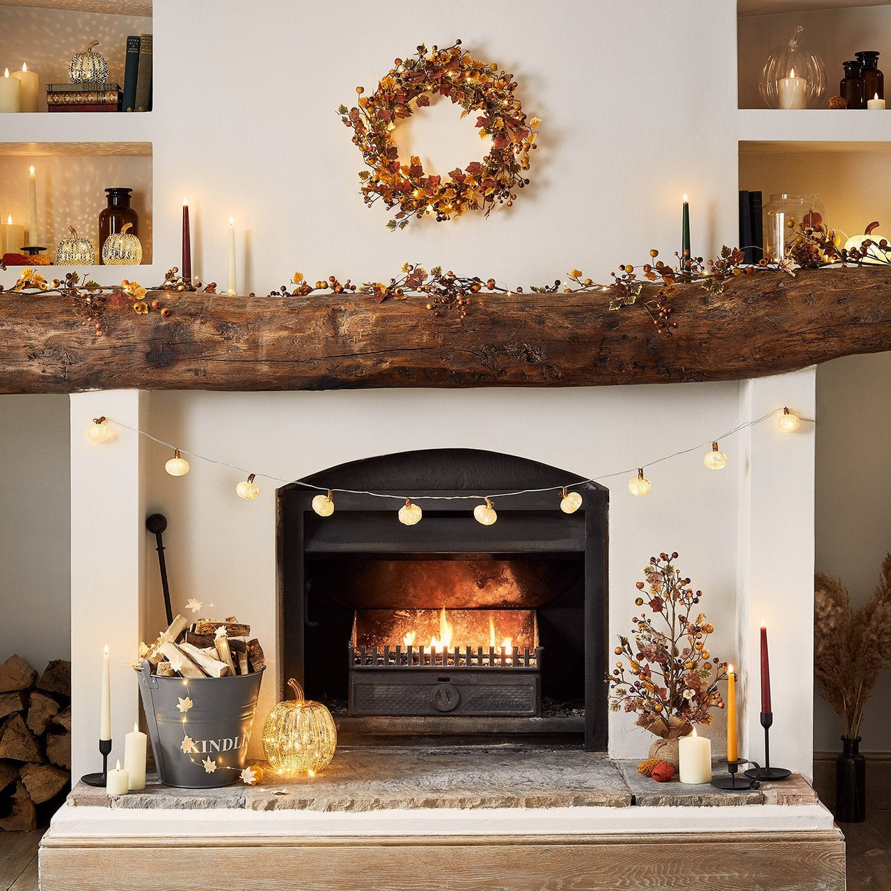 Autumnal-Halloween-Pumpkin-Fireplace-Display-With-Fairy-Lights-Wreaths-And-Candles.jpg