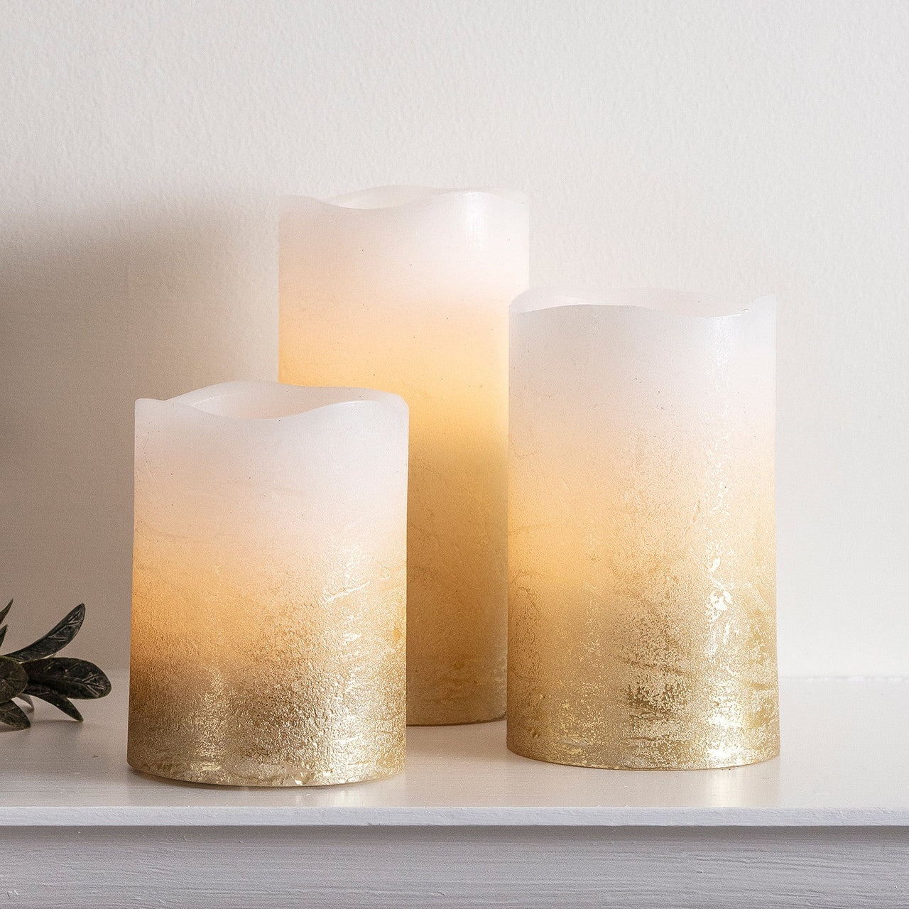 CA17004_Set-Of-3-Gold-Ombre-LED-Wax-Pillar-Candles-Close_P1.jpg