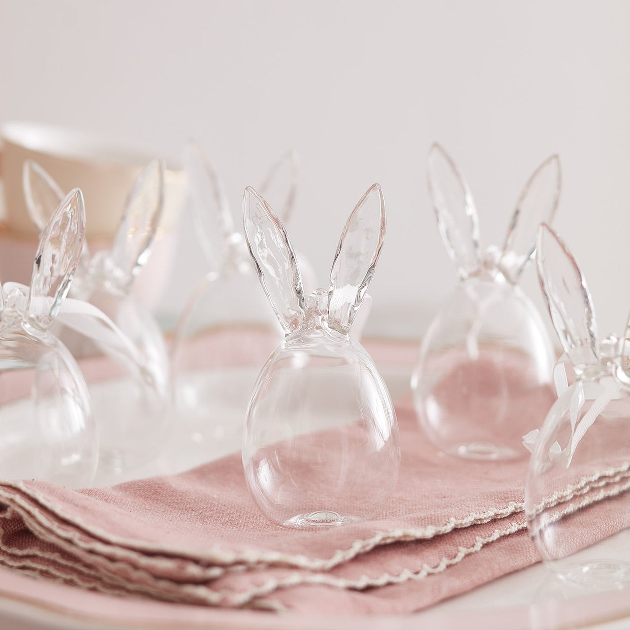 DE23002_set-of-6-glass-bunny-egg-decorations-clear-table.jpg