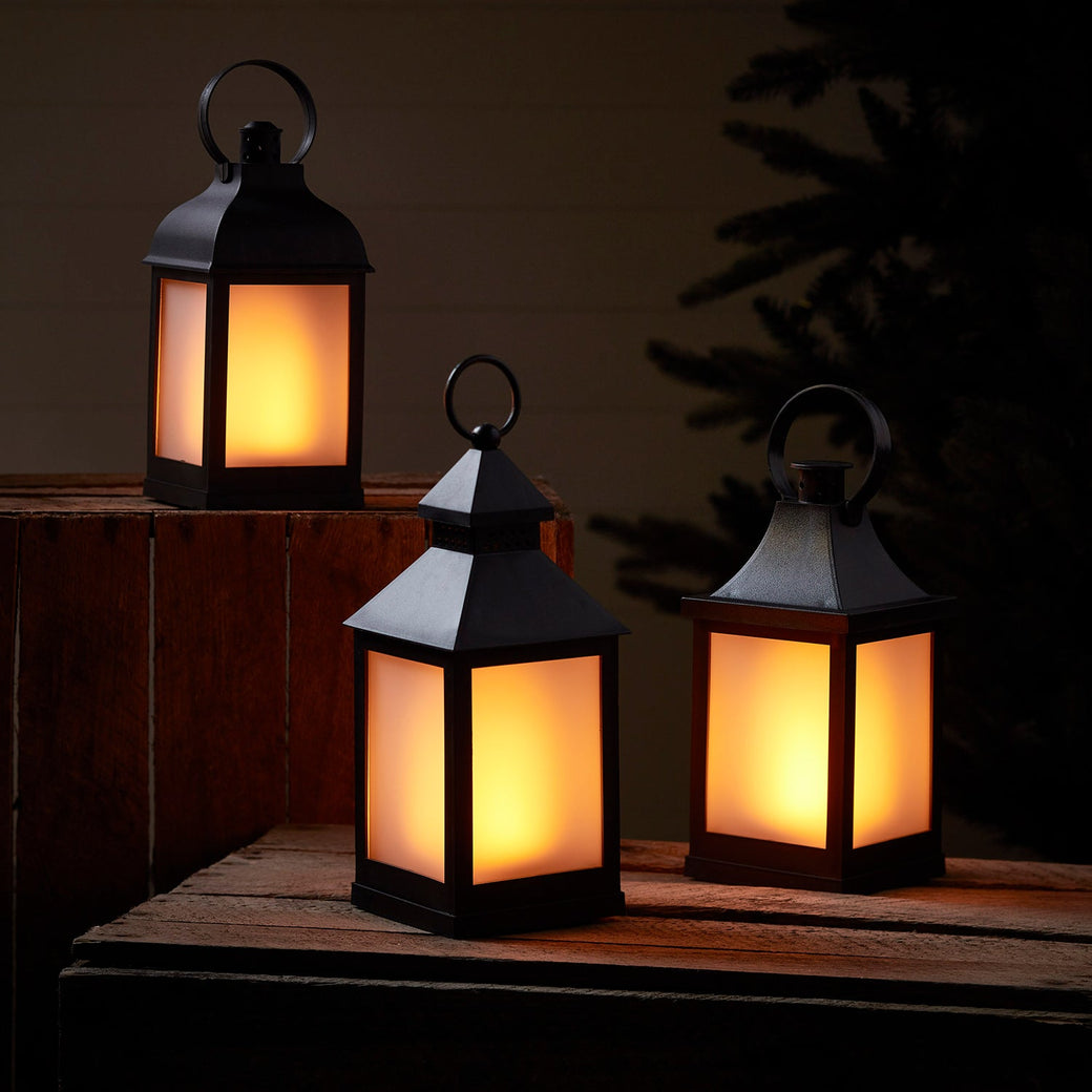 LA19013_3-Flame-Effect-Garden-Lanterns-In-A-Night-Time-Setting.jpg