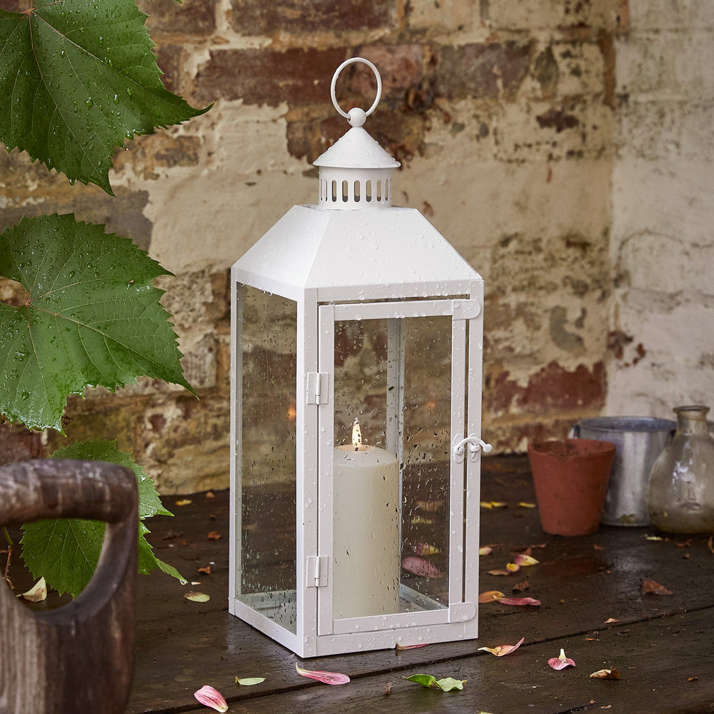 LA20015_perth-medium-white-garden-lantern-with-truglow-candle-outside.jpg