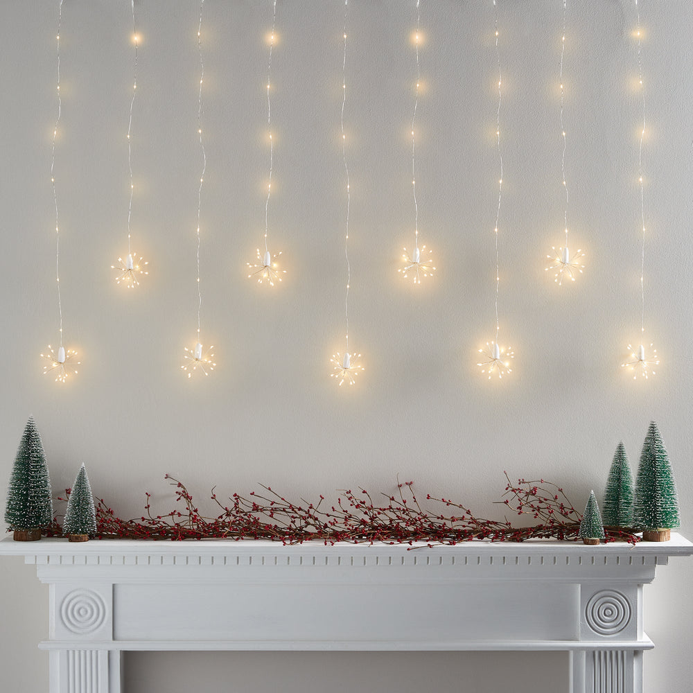 PL21046_Warm-White-Starburst-Curtain-Light-Above-Christmas-Mantel-Off-On_1.jpg