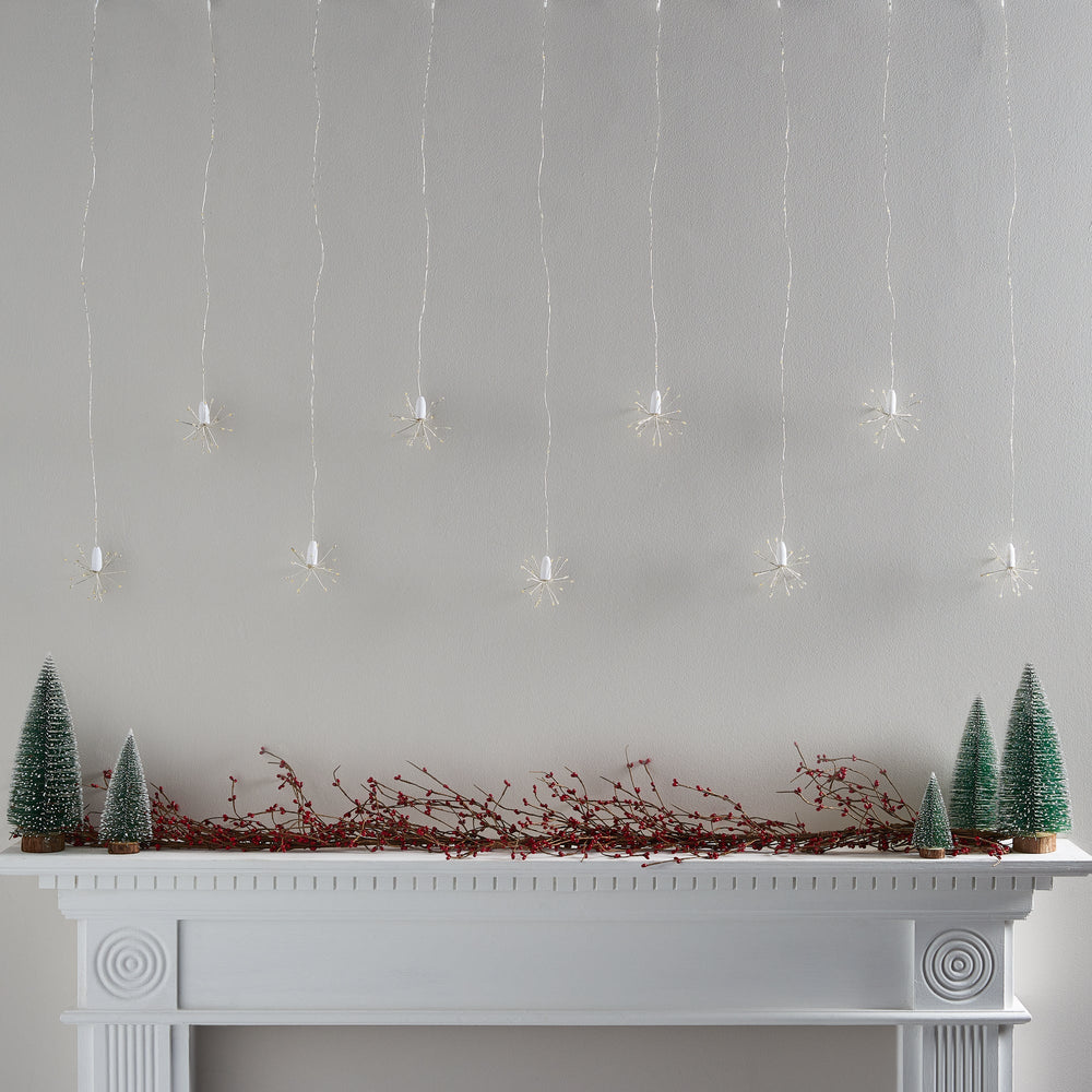 PL21046_Warm-White-Starburst-Curtain-Light-Above-Christmas-Mantel-Off-On_2.jpg